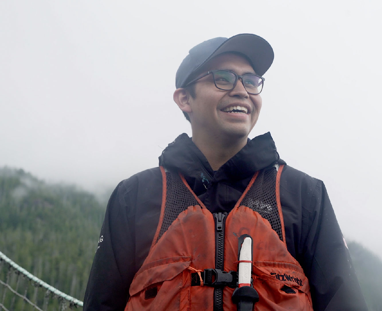 A salmon farmer laughing outside.